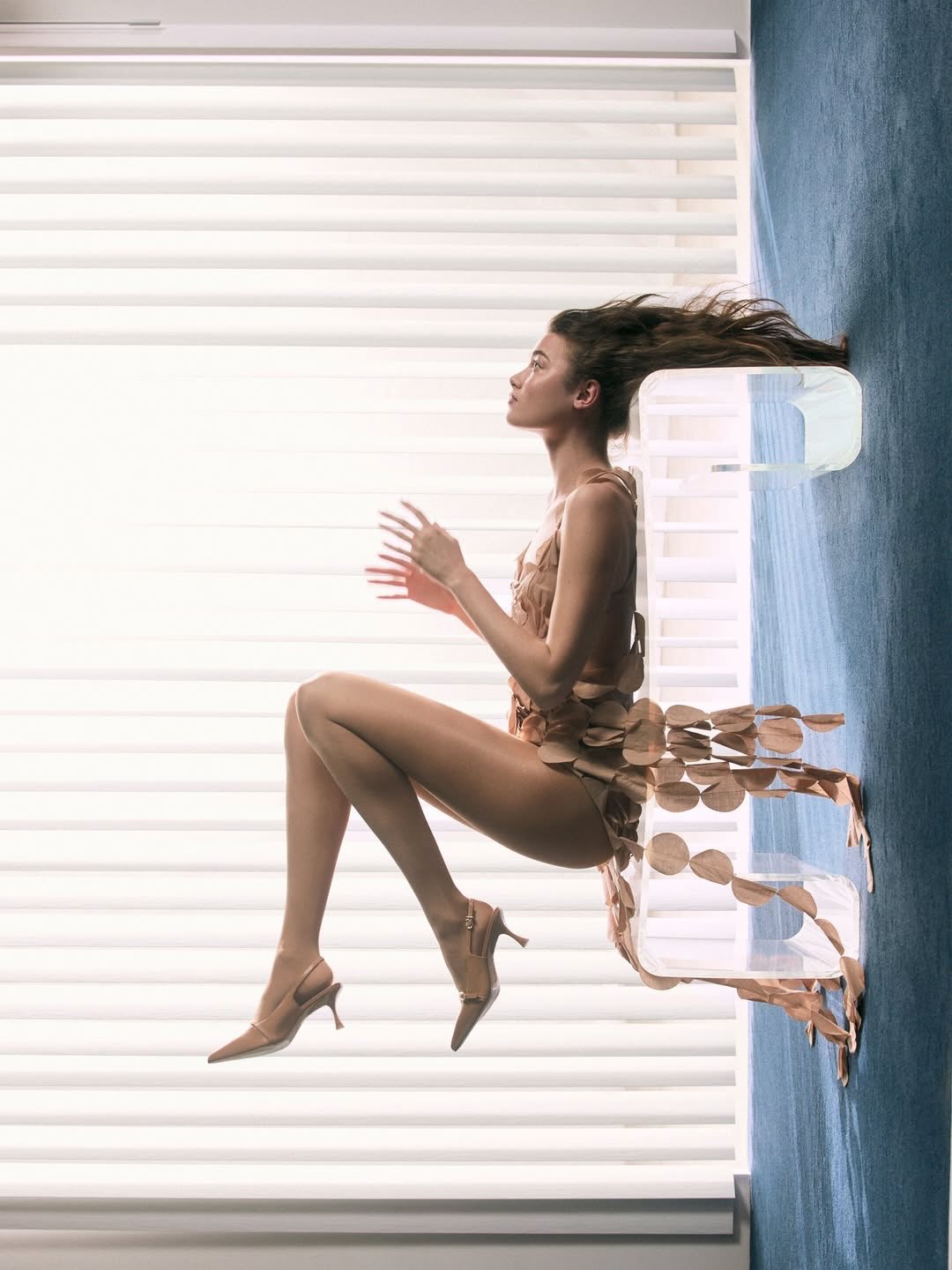 Numéro Netherlands fashion editorial with Kennidy Hunter and a sculptural transparent chair, presented in its original sideways composition